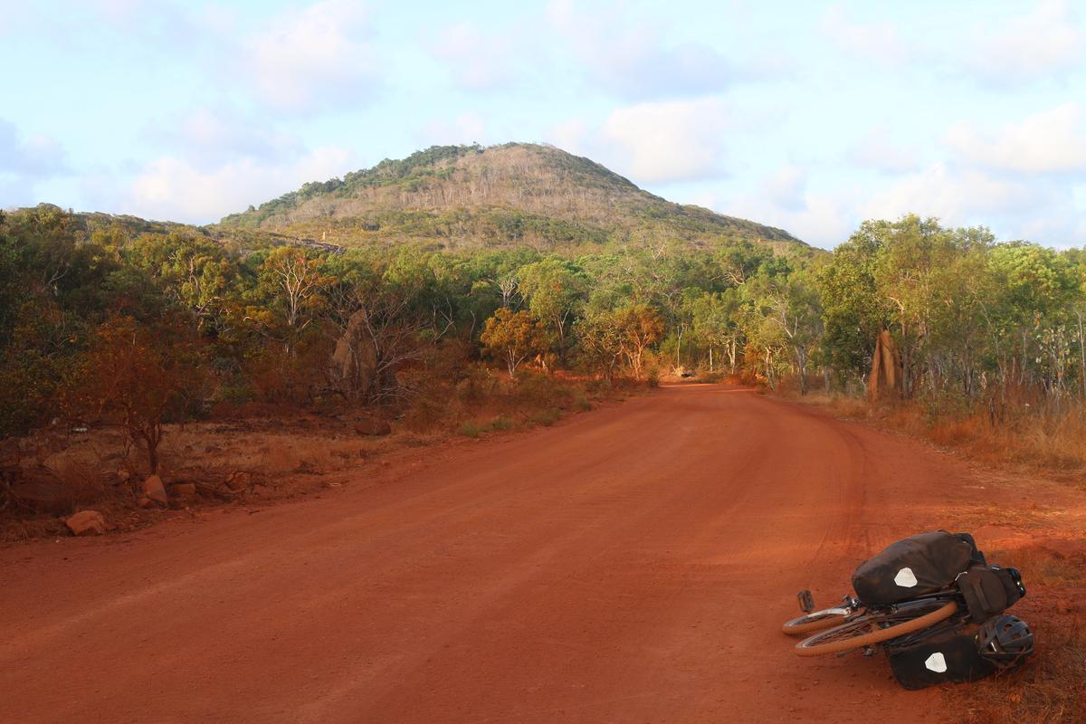 My bike lying beside a red dirt road as I cycled to the tip of Cape York on my trip around Australia