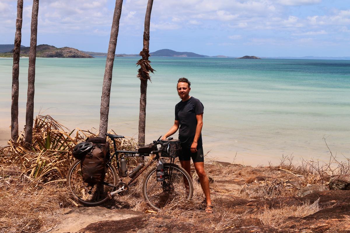 Me standing with my bike at the tip of Cape York, the northern most point of Australia