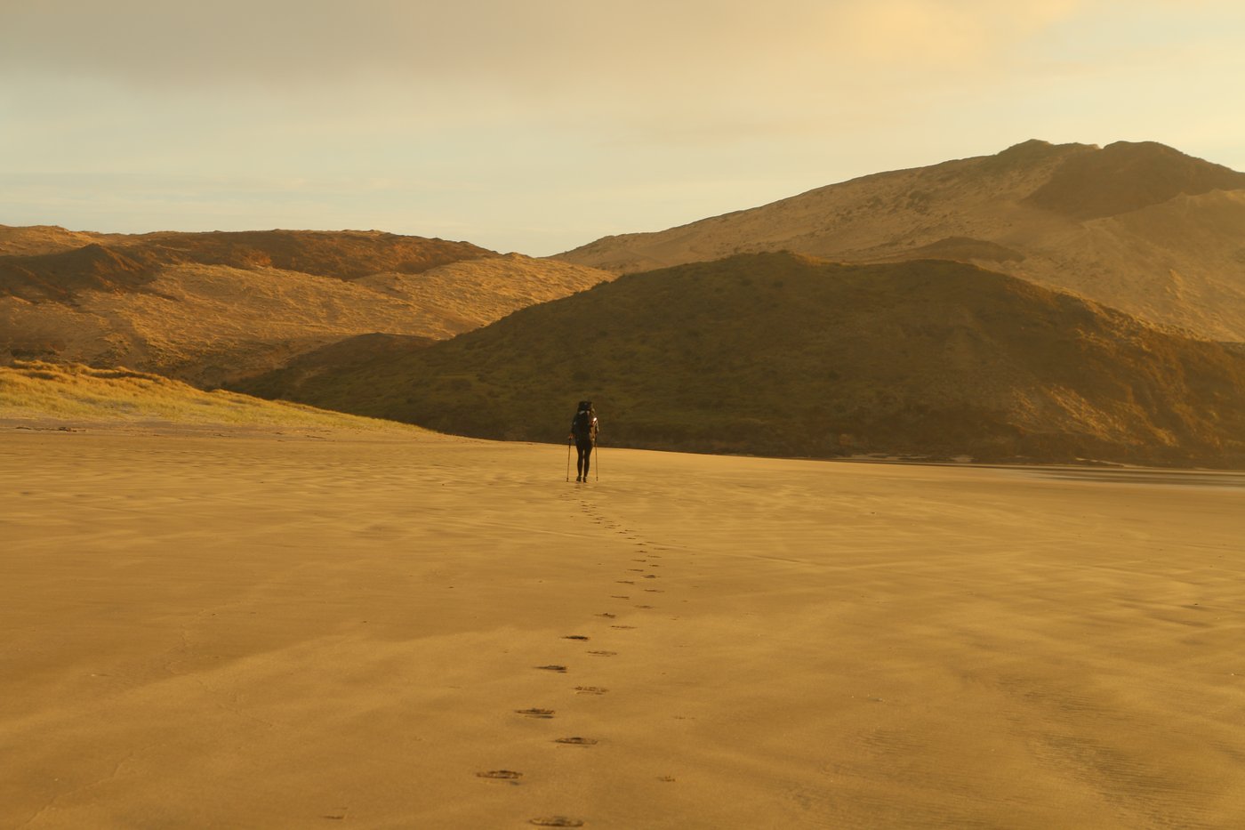 Rose’s footsteps visible in the sand, Rose distant.