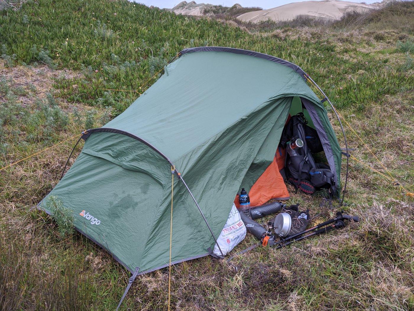 Our tent amongst the grasses behind the dunes.