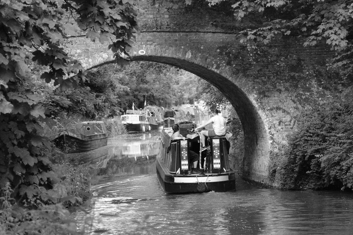 A narrowboat passes under a bridge