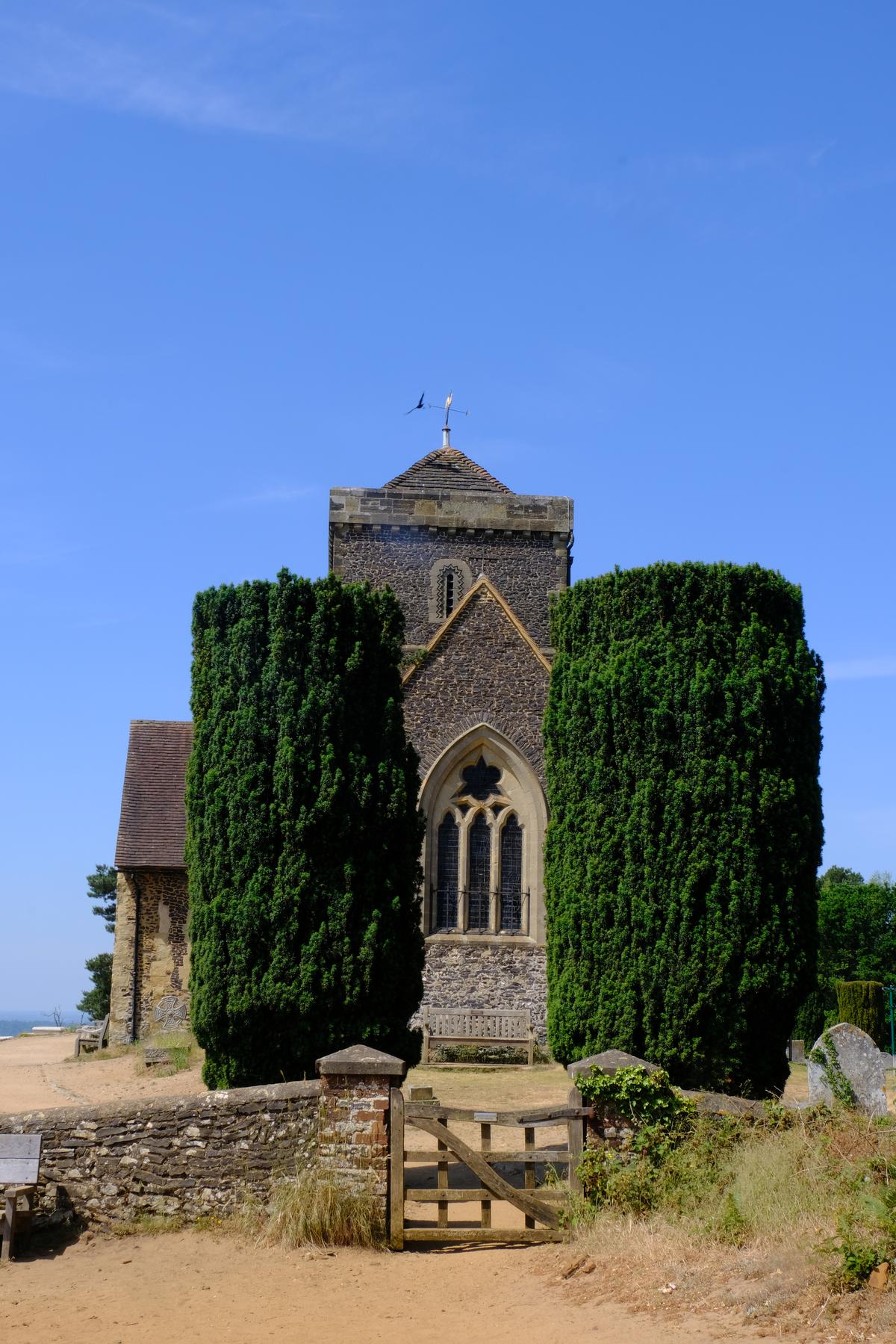 A hilltop church and two great green bushes