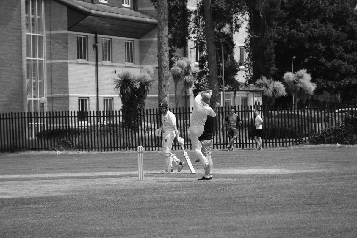 A local cricket bowler in mid throw