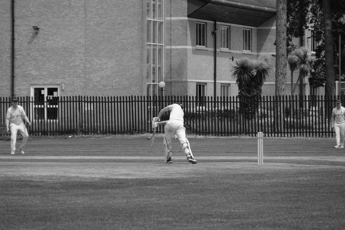 A batsman in the instant before the cricket ball strikes his bat