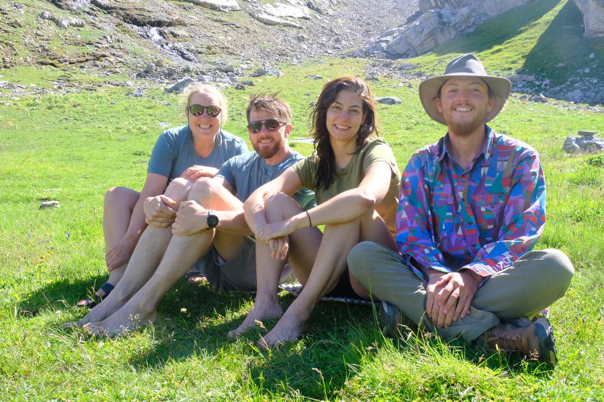 Tamara, Matias, Jasmin, and I; sat beside a shallow lake after walking together for the day. Switzerland