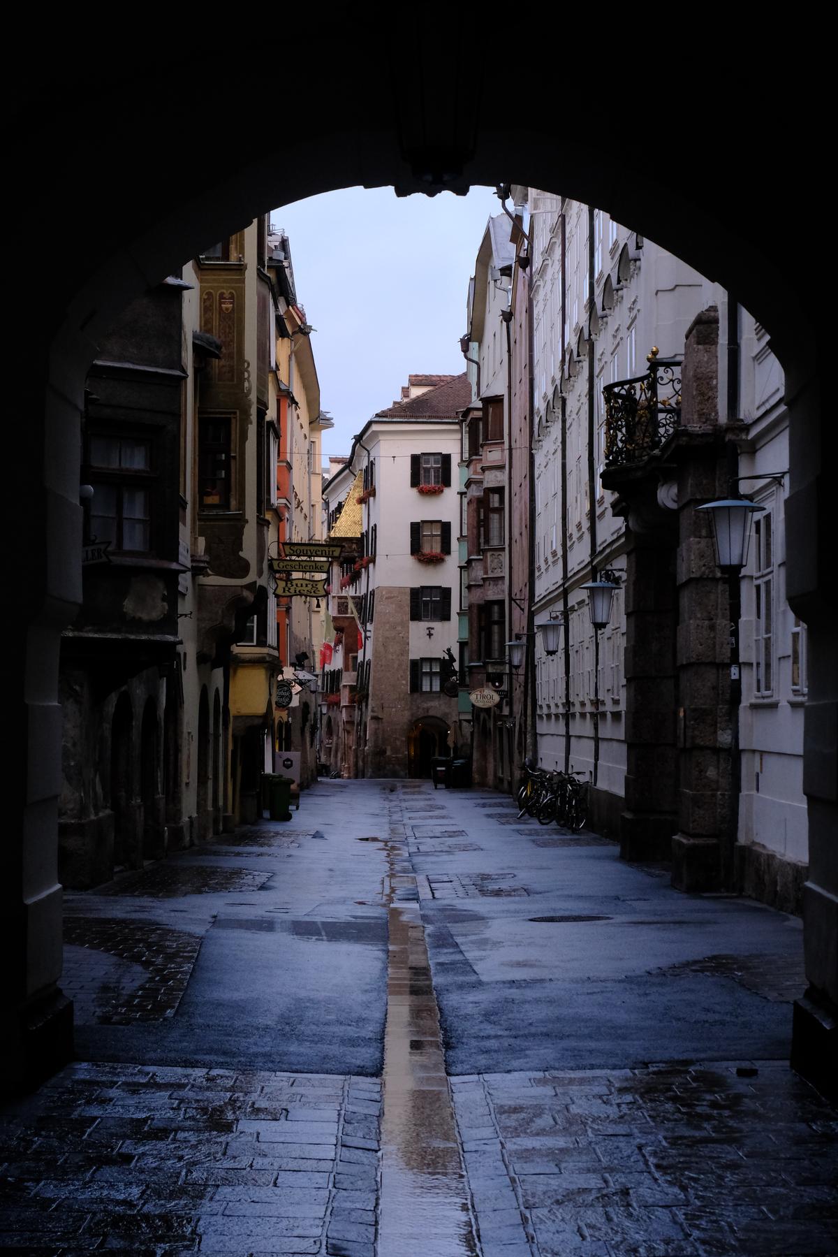 Looking down a street, through a tunnel after rain in Innsbruck, Austria