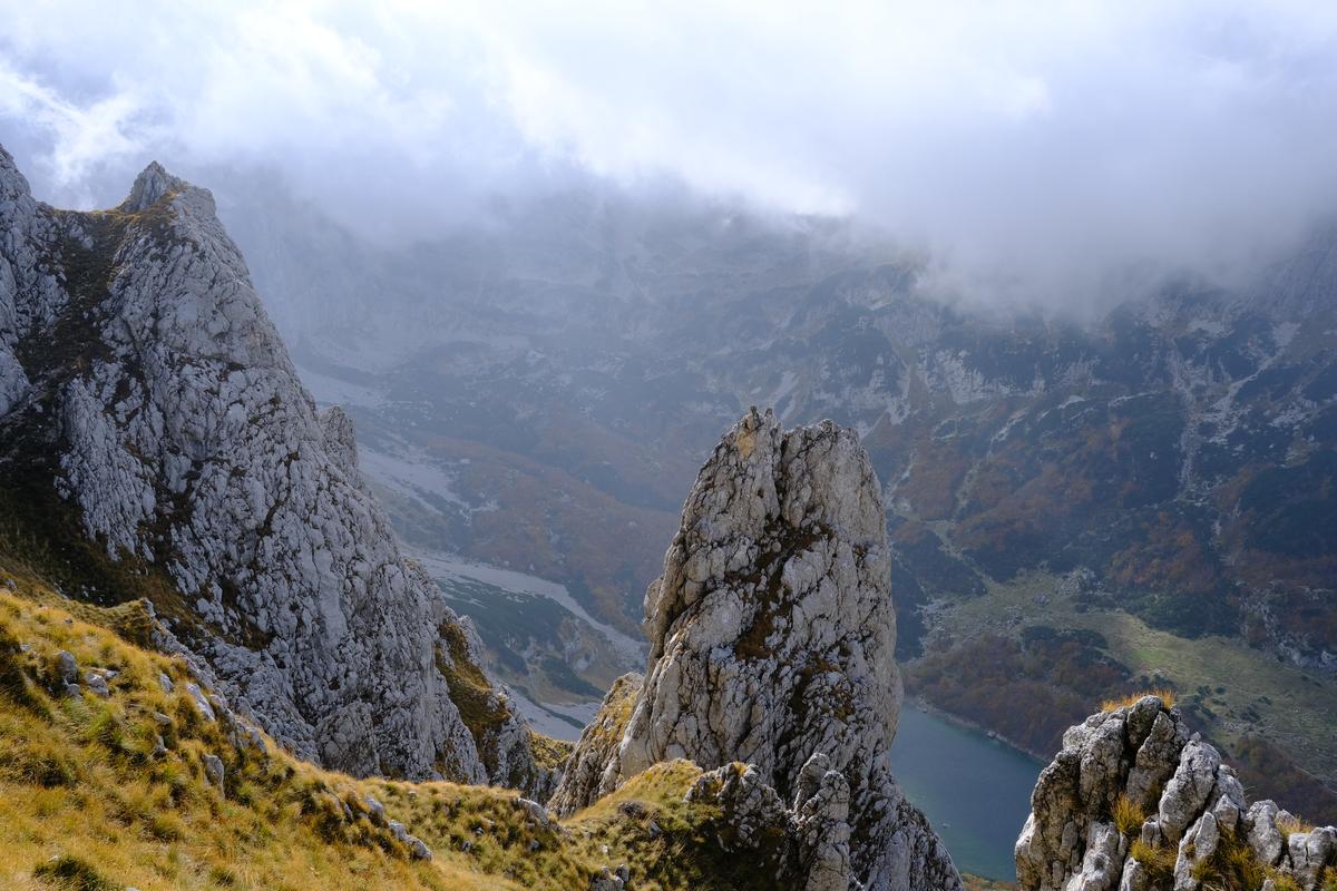 Rocky bluffs and low cloud above Lake Sušičko in the Durmitors, Montenegro