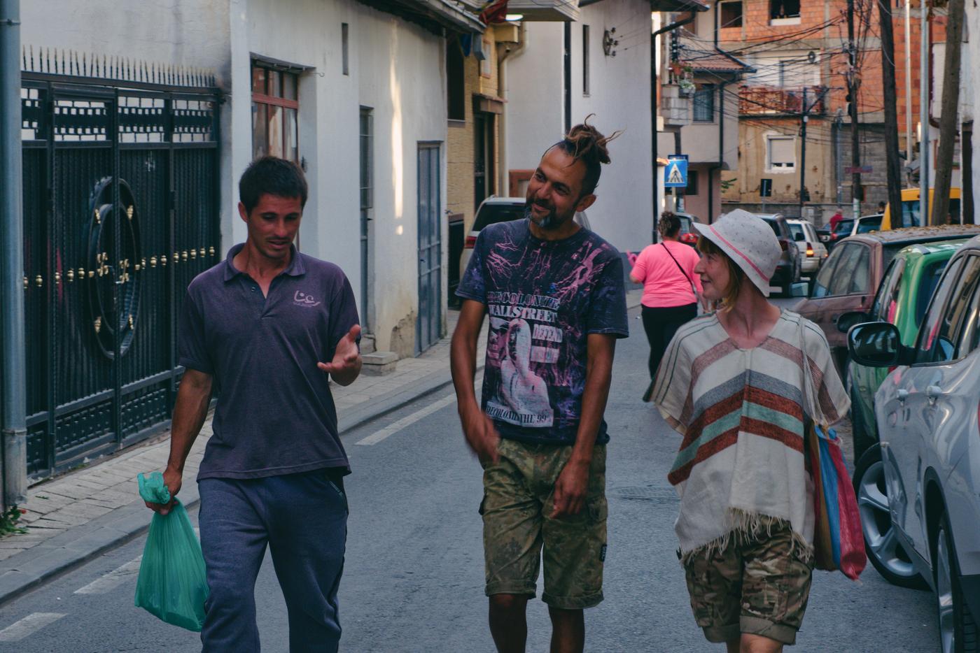 Irfaan and Helen listen while Mohammed speaks animatedly about migration. Prizren, Kosovo