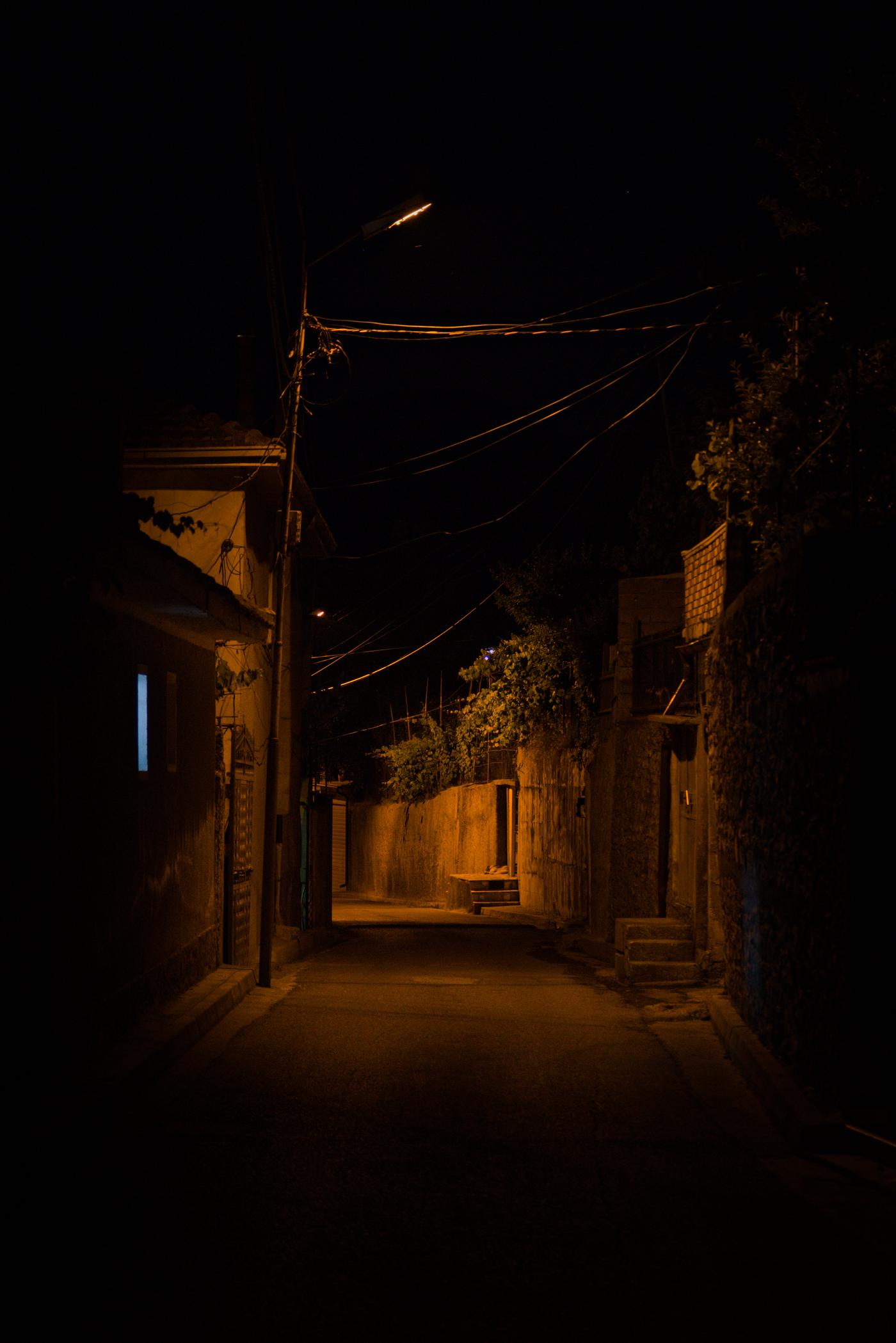 A dimly lit alley leads me into Peshkopi after descending from the mountains. Albania