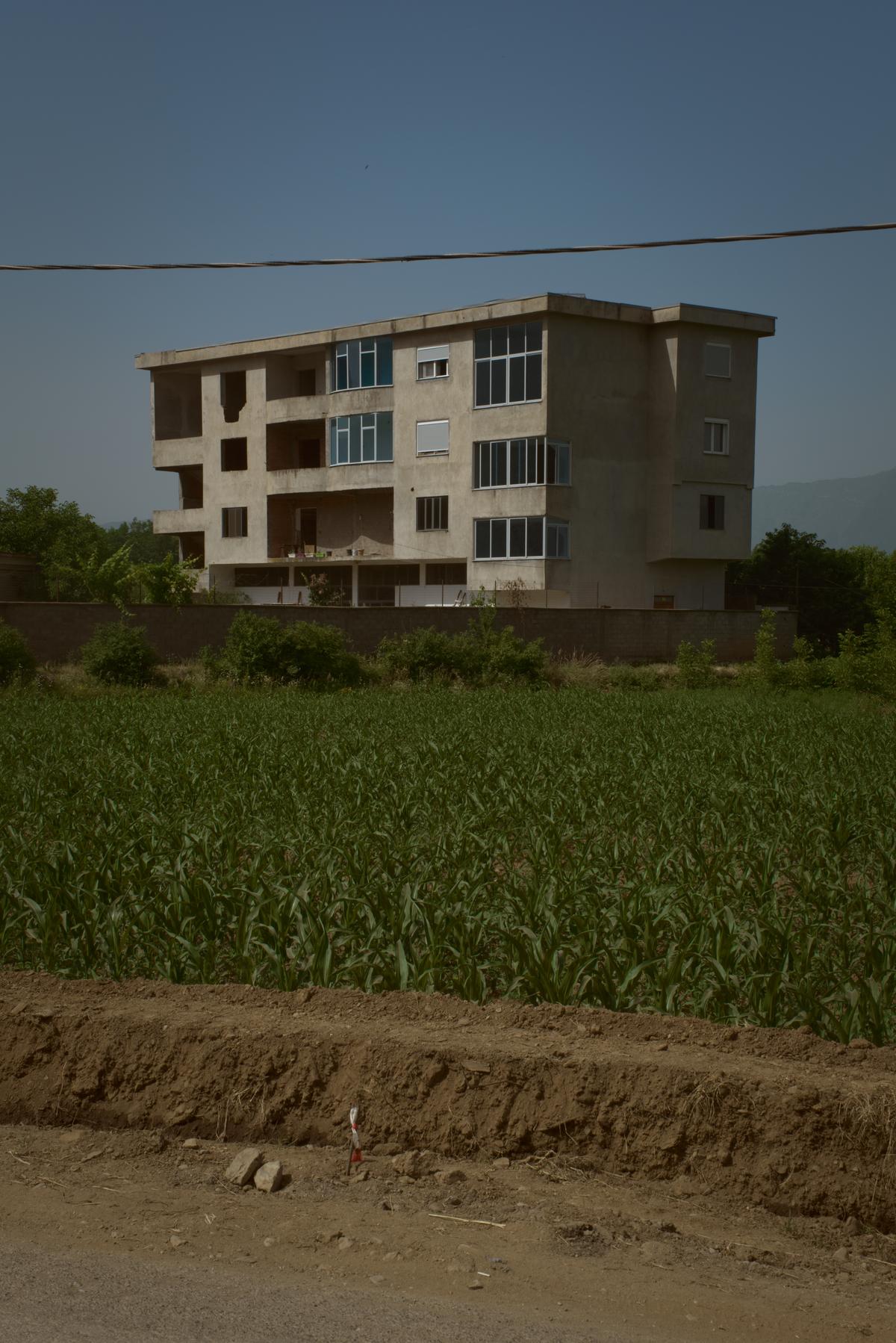 A half finished rural apartment building, a common sight in Albania