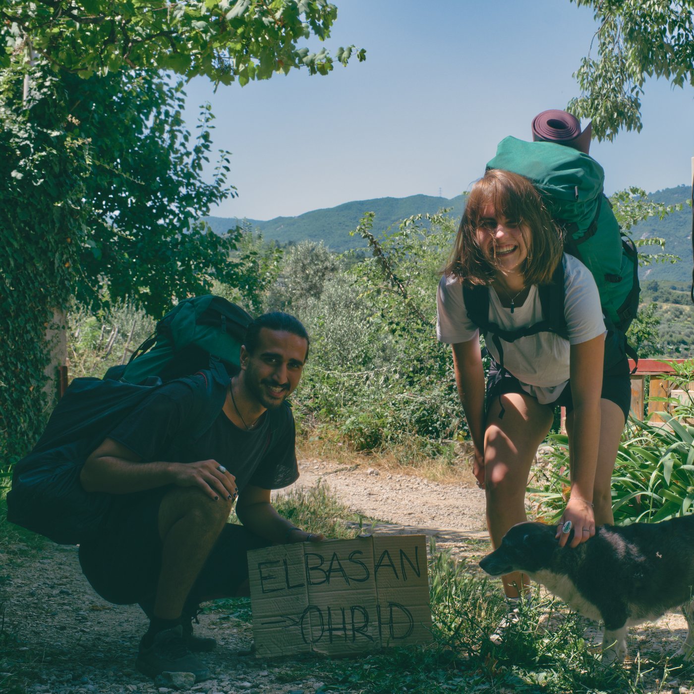 Arsalan and Anikka on their way out the gate to hitch to Lake Ohrid. Pëllumbas, Albania