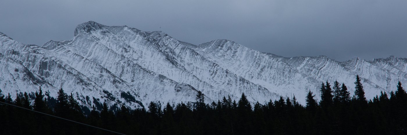 A ridgeline of the Rockies, dusted with snow. Kananaskis region, Canada