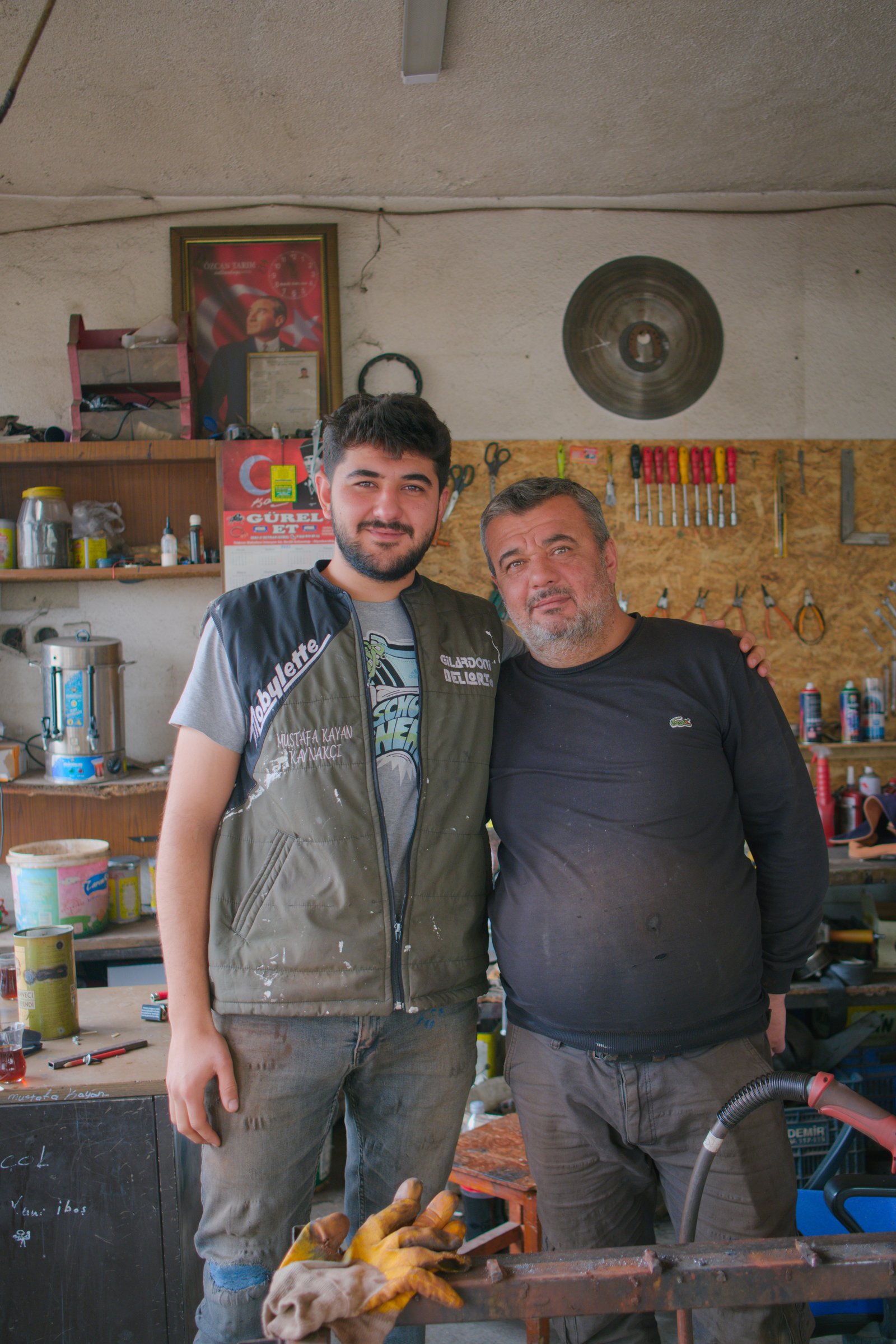 Volkan and his son, Mustafa, in their welding shop.