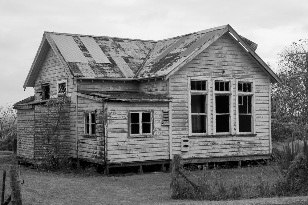 An abandoned house beside the road.