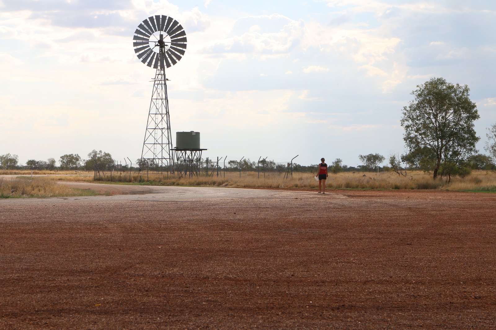 Anna walking toward a very welcome roadside water tank