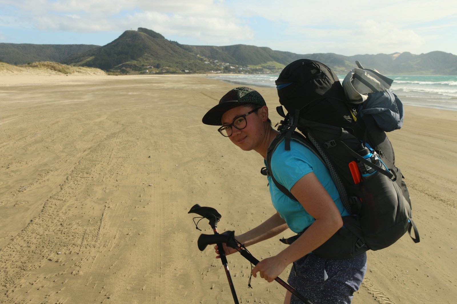 Houses dot the hillside in the distance behind Rose.
