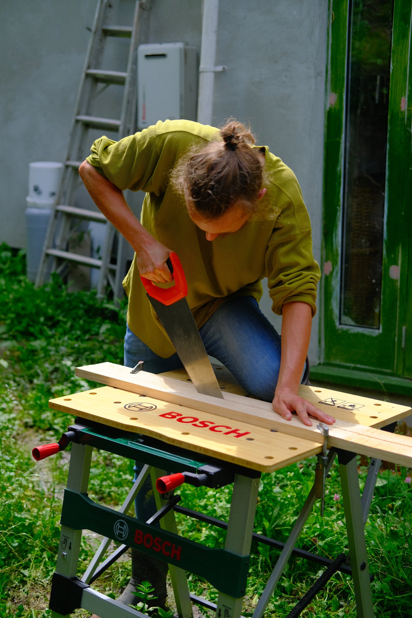 Sawing a length of timber in half.