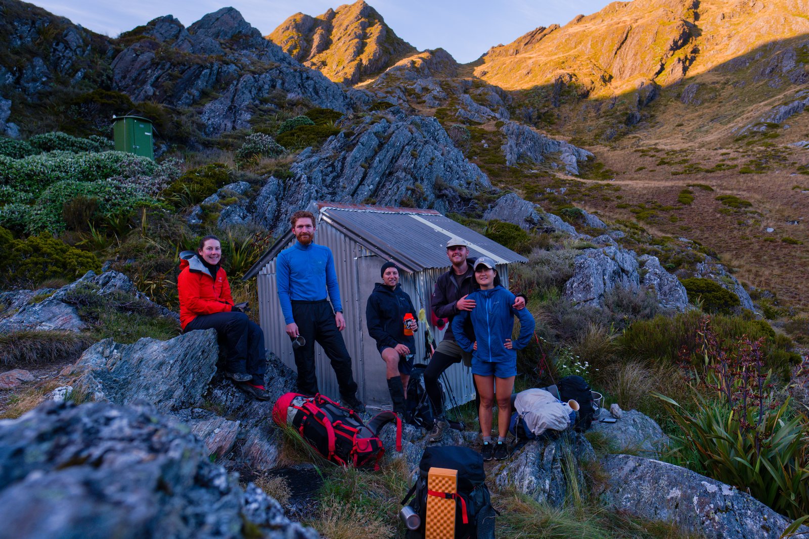 Chelsea, Manu, Miles, myself, and Mizuki in front of Adelaide Tarn Hut on the morning of our crossing over the Dragon's Teeth. Kahurangi National Park, New Zealand