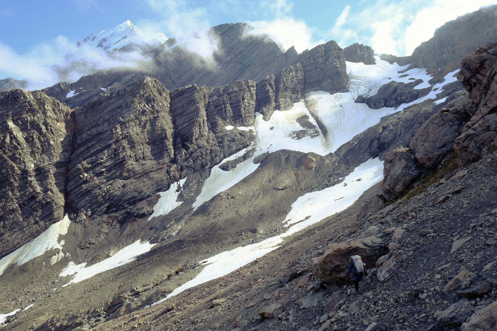 Mizuki picks her way across a scree slope on our climb up to Ball Pass. Aoraki National Park, New Zealand