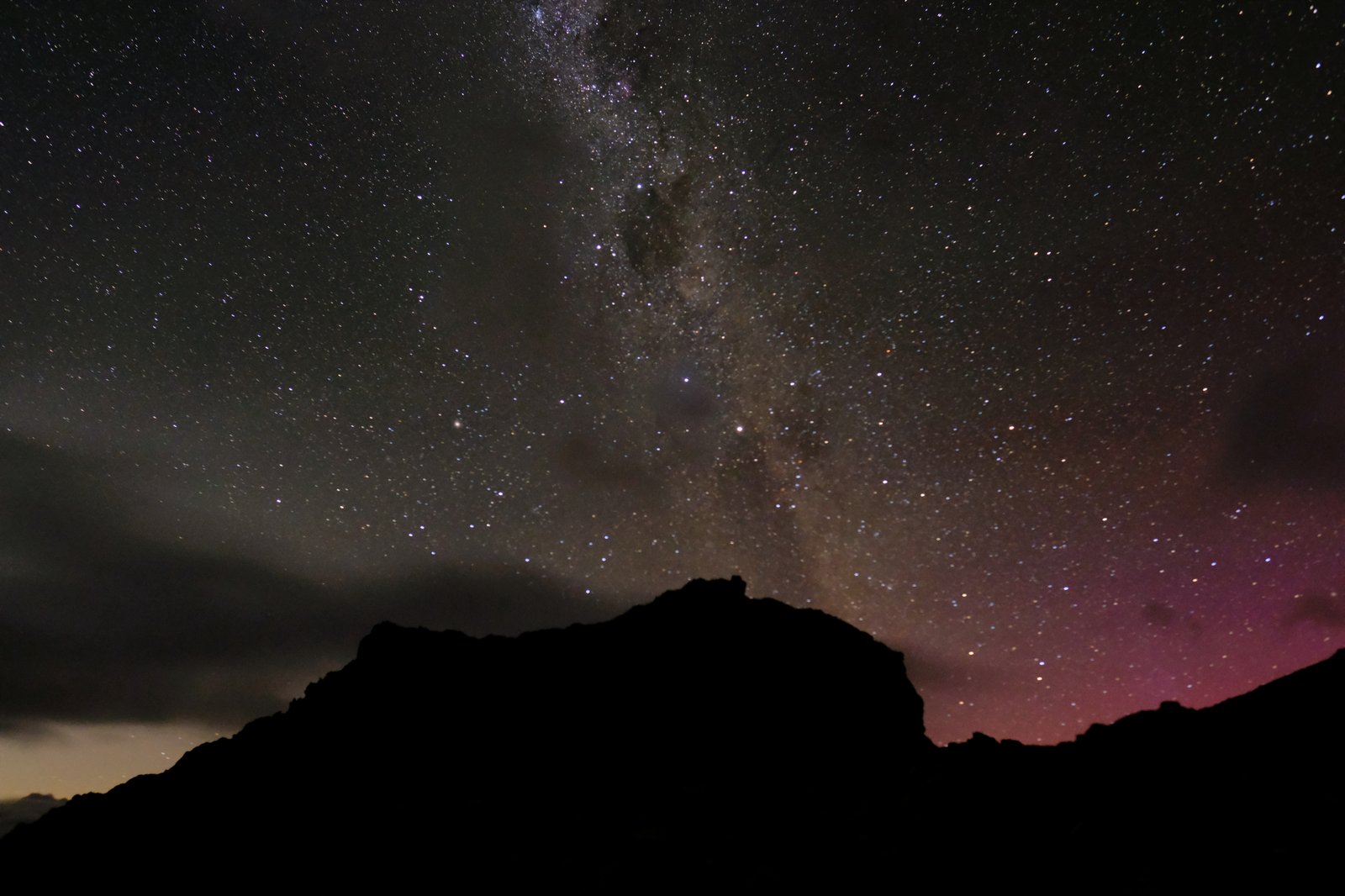The stars and the red light of the aurora as seen from Ball Pass, New Zealand.
