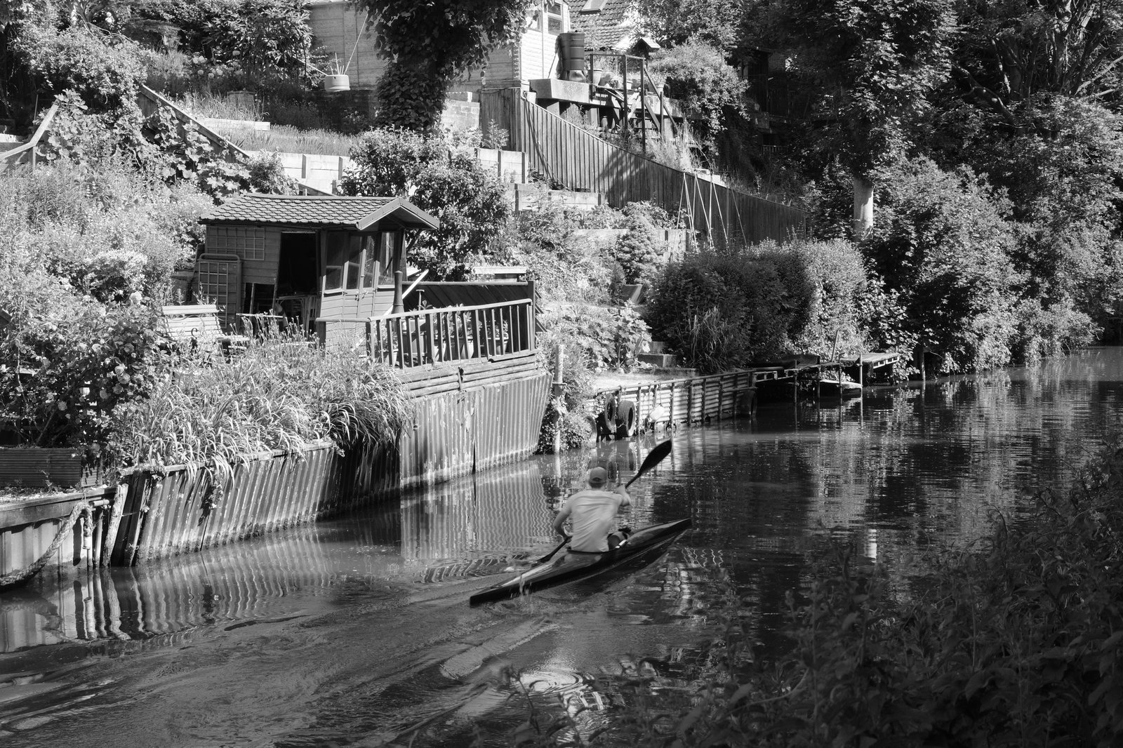 A kayaker powers along the canal
