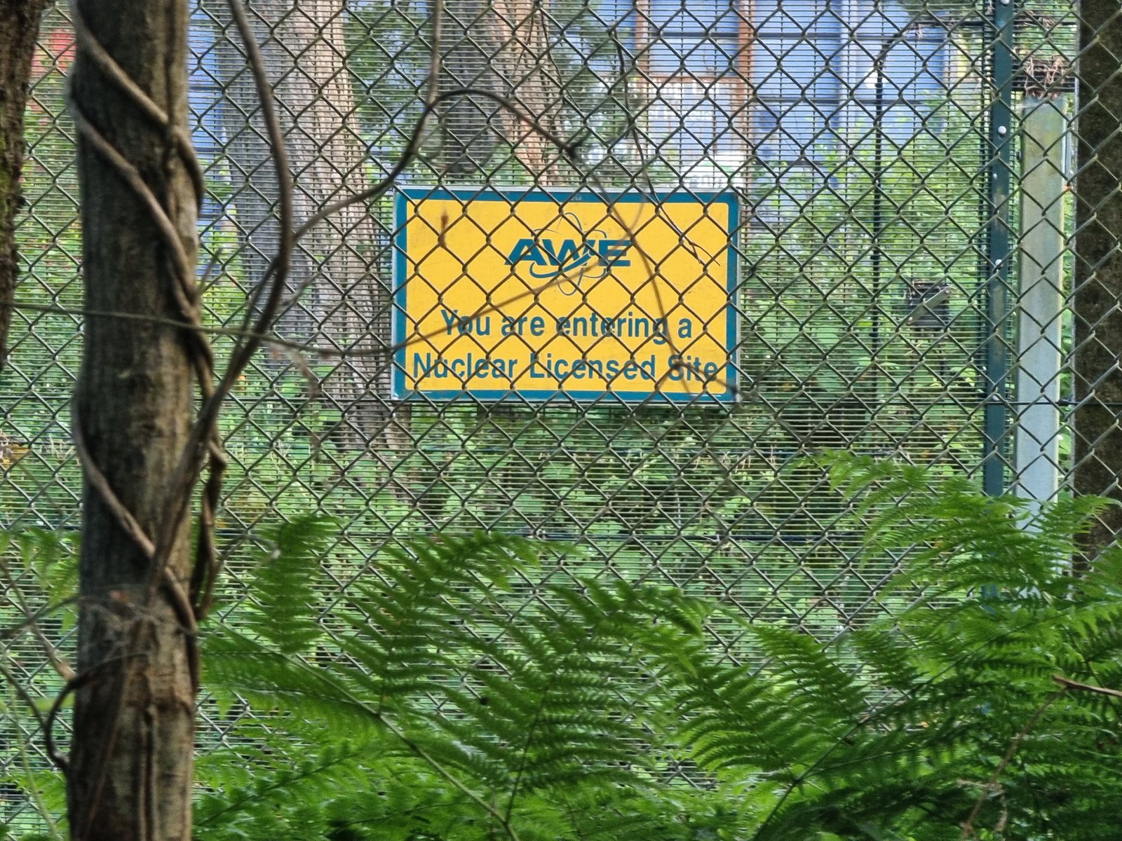 A sign on a fence reads 'You are entering a nuclear zone'