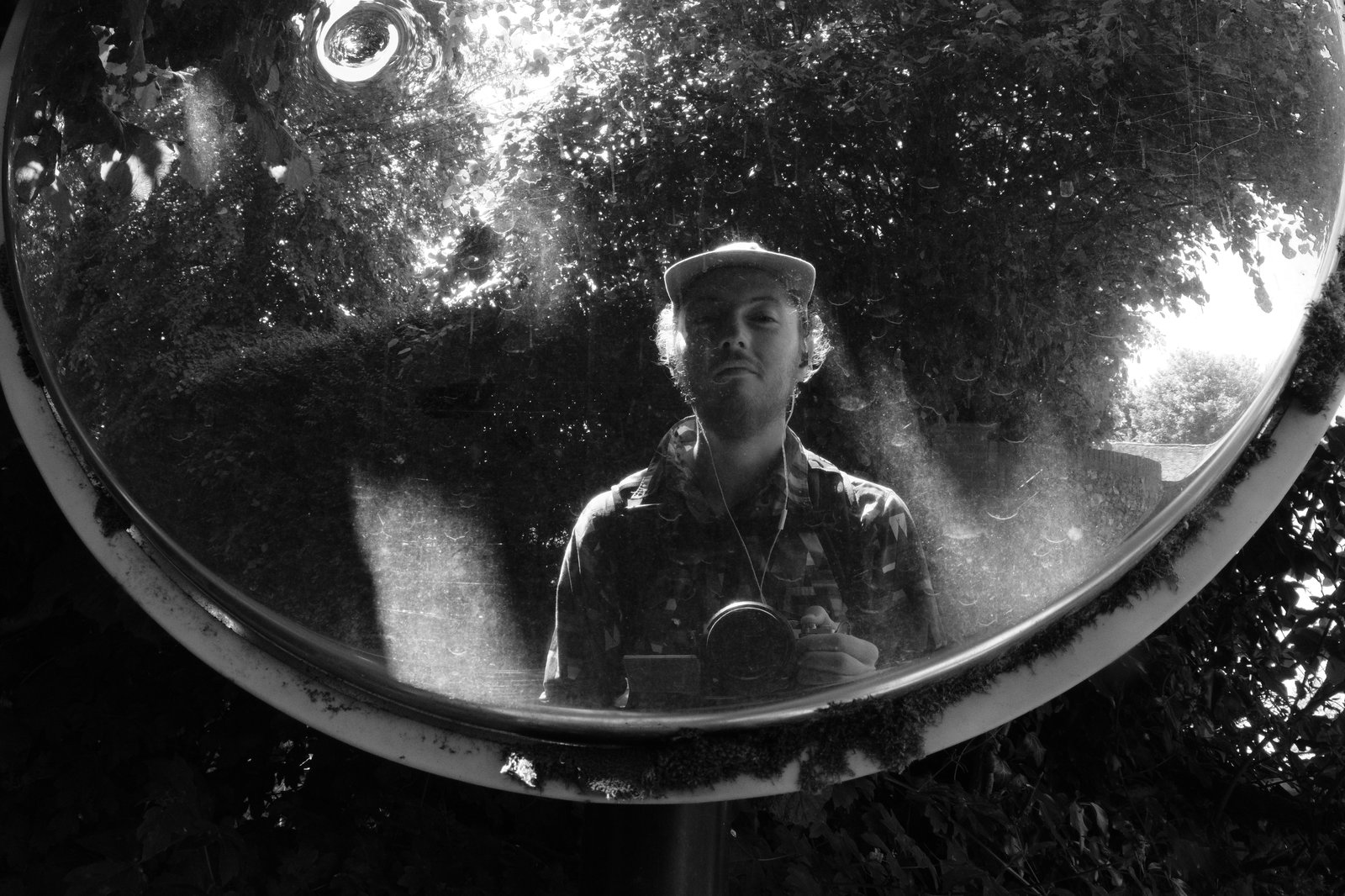 The author's smug looking expression reflected in a driveway mirror