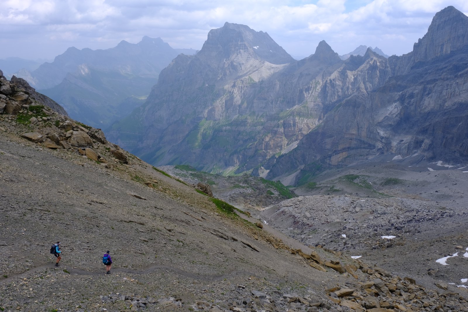 Marie, who had advised me as to the coming need to speak German, and her hiking companion begin a descent from a rocky col into a lush valley. Switzerland