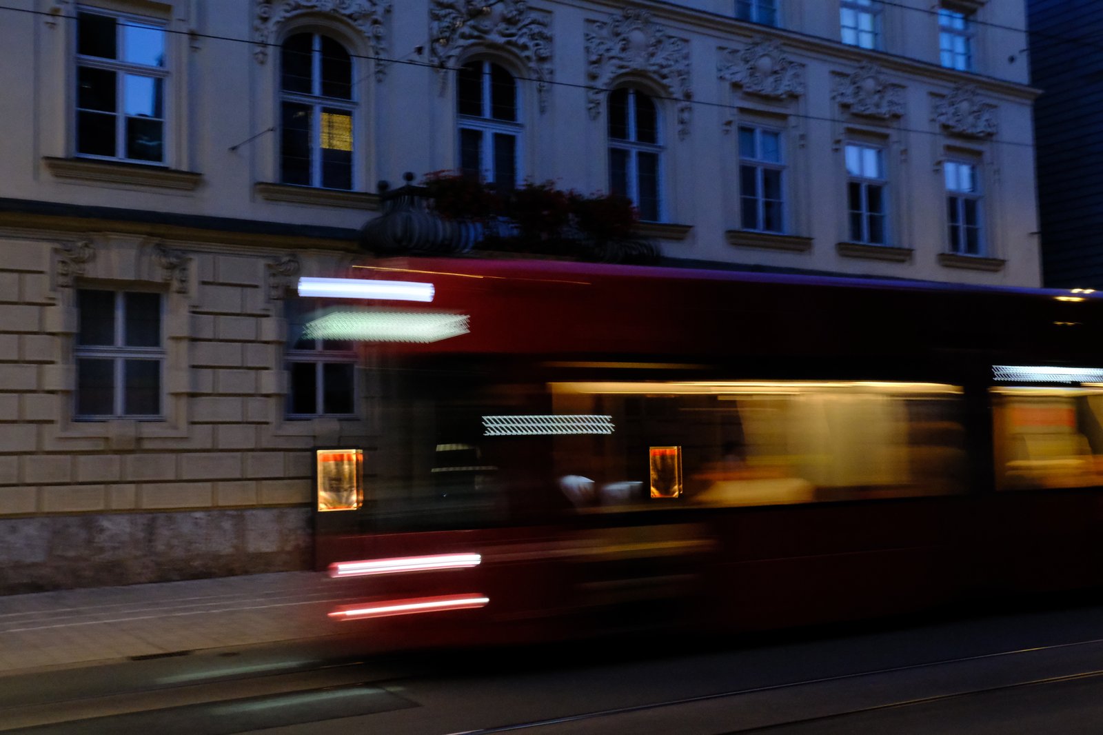 A red tram passes by in a blur. Innsbruck, Austria