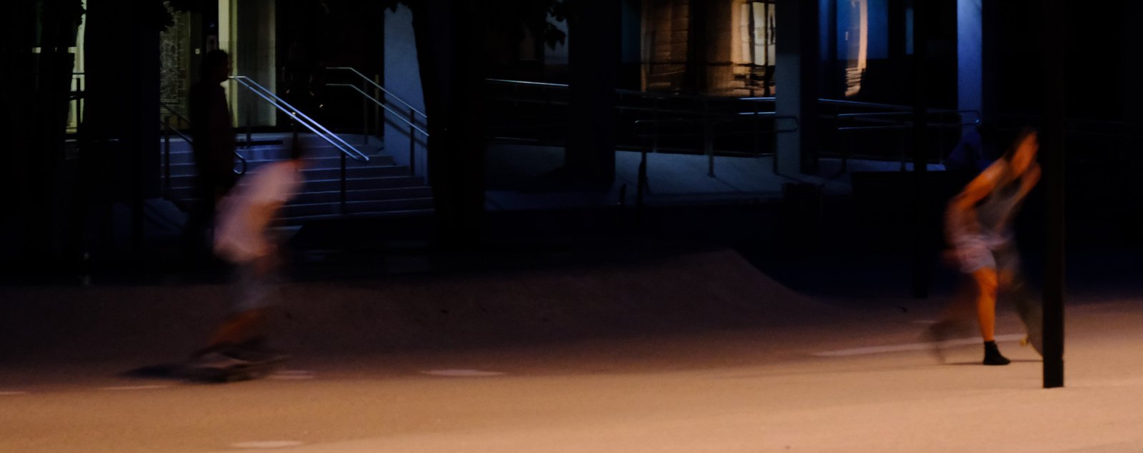 Two skaters in a blur of motion. Innsbruck, Austria