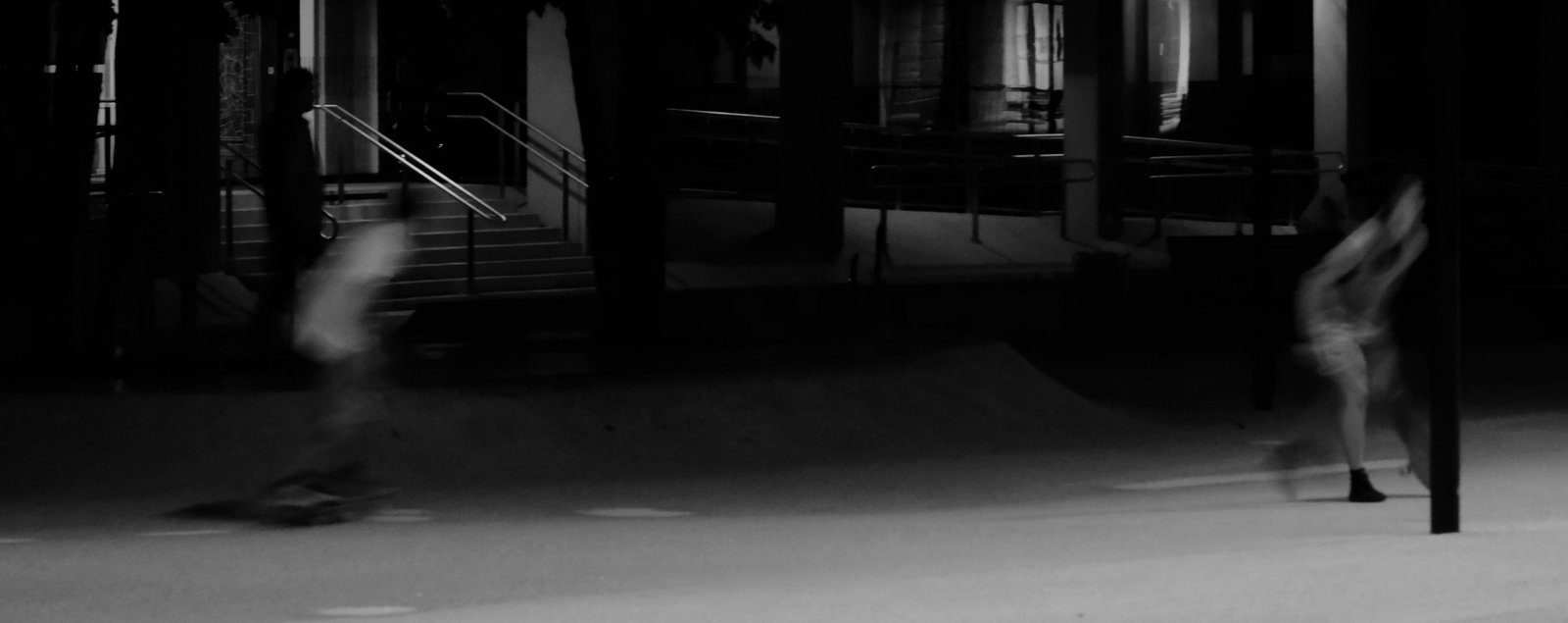 A black and white of the two skaters in a blur of motion. Innsbruck, Austria