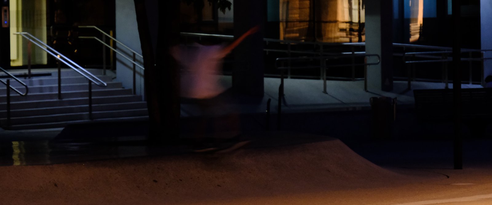 A skaterboarder in a blur as they grind the top of a bank. Innsbruck, Austria