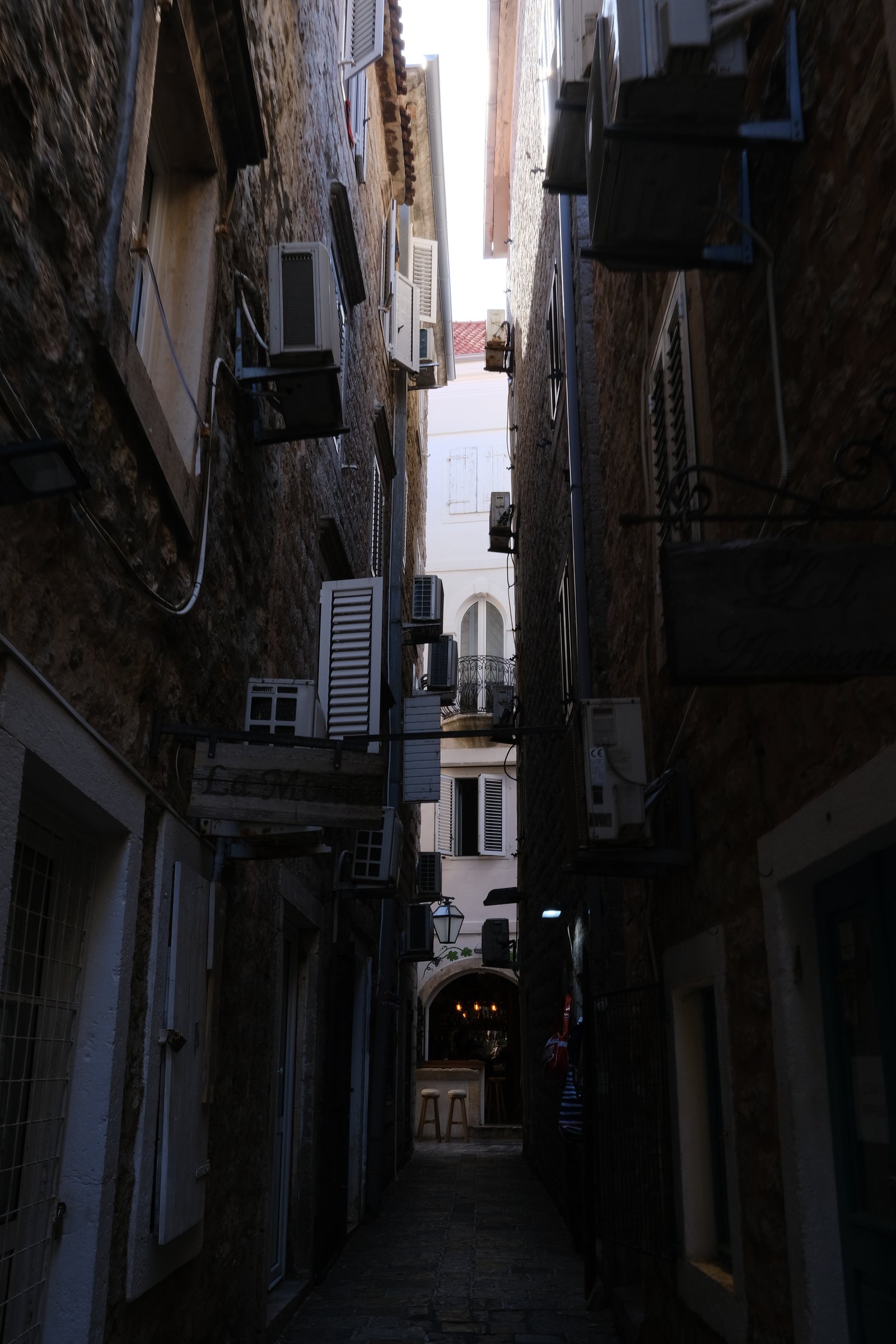 An alleyway cluttered with air conditioners in Old Town, Budva, Montenegro