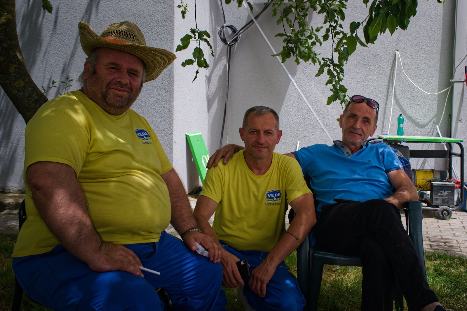 Prand, Wilson, and Gasper sit in the shade of a cherry tree outside Gasper's gas station. Between Gjakovë and Prizren, Kosovo
