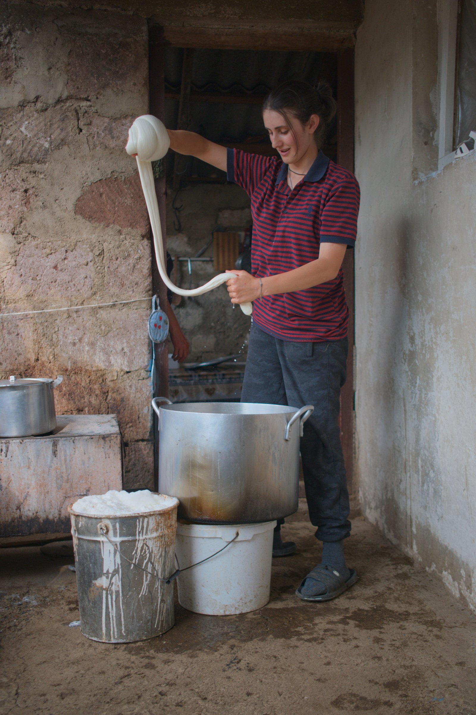 Arpine (Արփինե) demonstrates part of the process they use for making cheese on their summer farm. Armenia