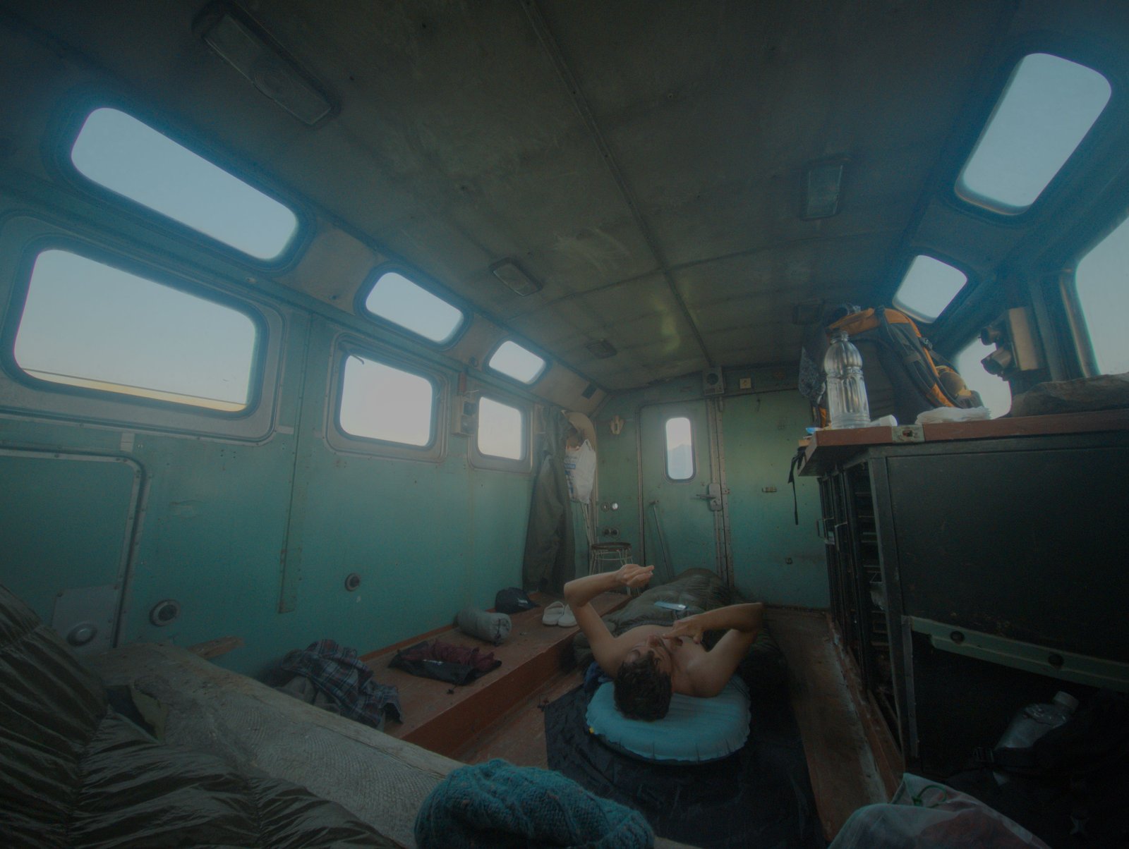 6AM: Jonny rubs balm into his lips while we idle and chat in the Soviet caravan that was our shelter for the night.