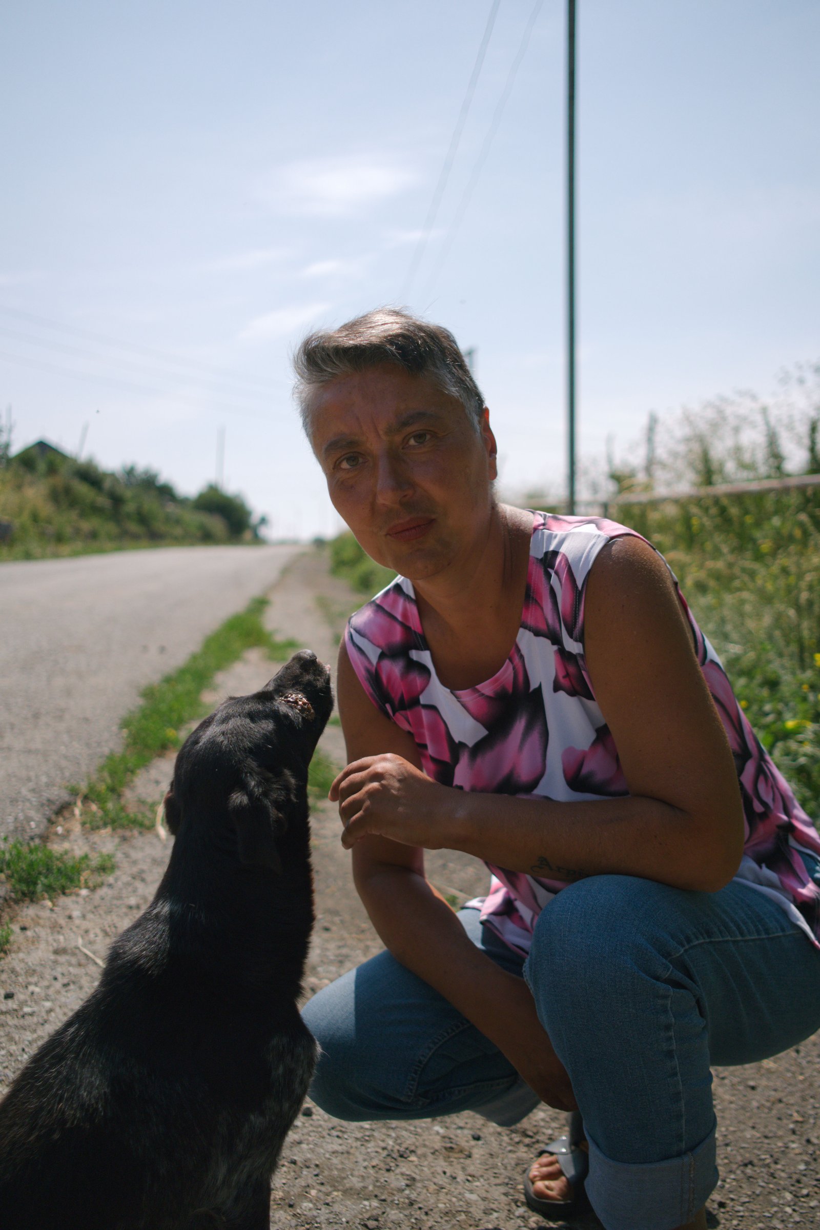 Arpine waits for a bus in the village Semyonovka. Armenia