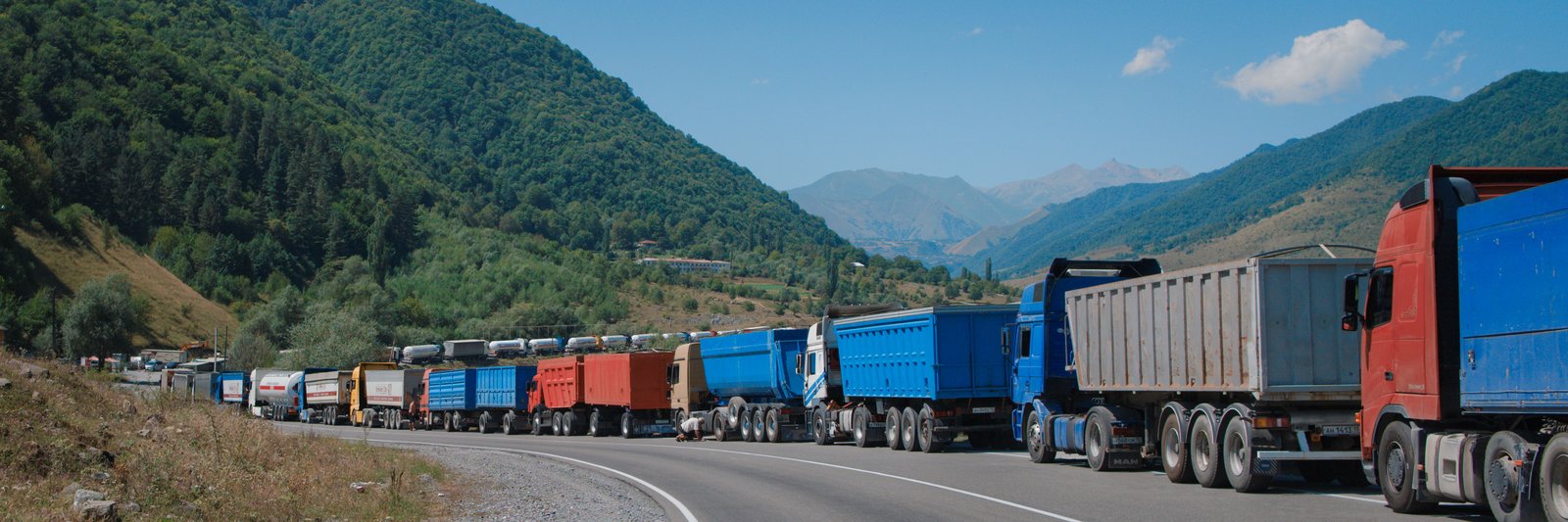 The winding road through the mountains made it impossible to capture the scale of the column of trucks, but this bumper to bumper train went on for kilometres at a time. Georgia, near the Russian border.