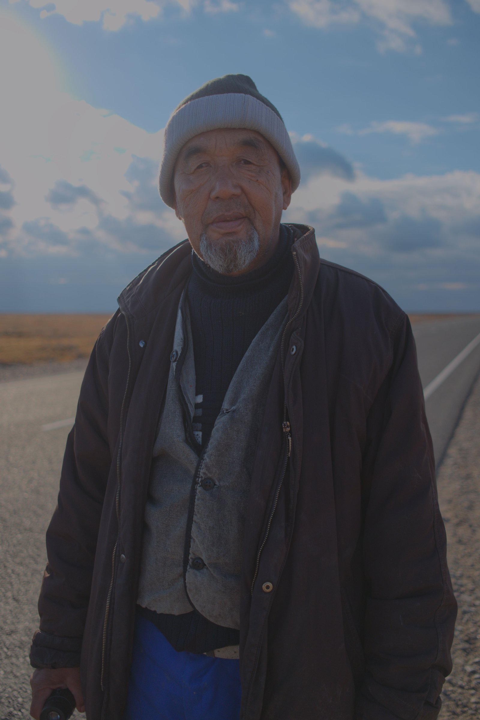 Qanat who beckoned me towards his bright blue Lada parked off in the sand dunes, and filled a little bag with dried apricots and dates, and a sweet bread. Western Kazakhstan.