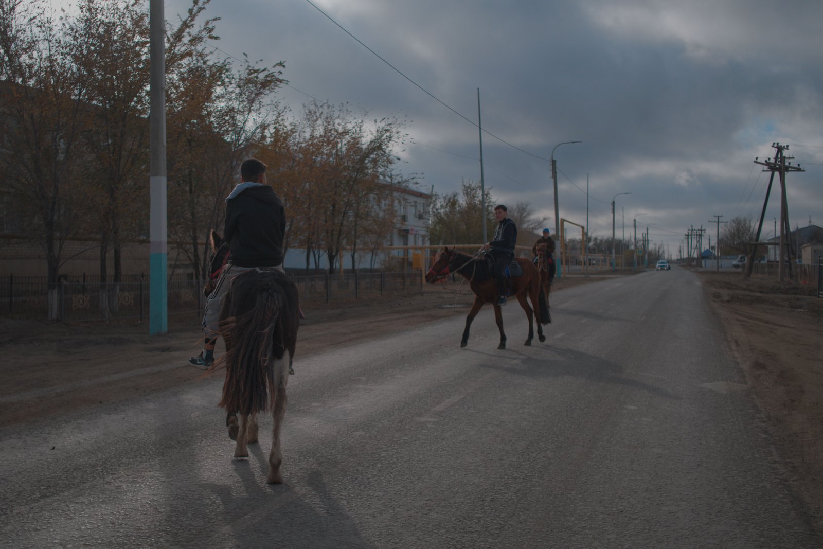 Äli, Daryn, and Maqsat riding through the streets of Akkystau while I miss focus. Kazakhstan