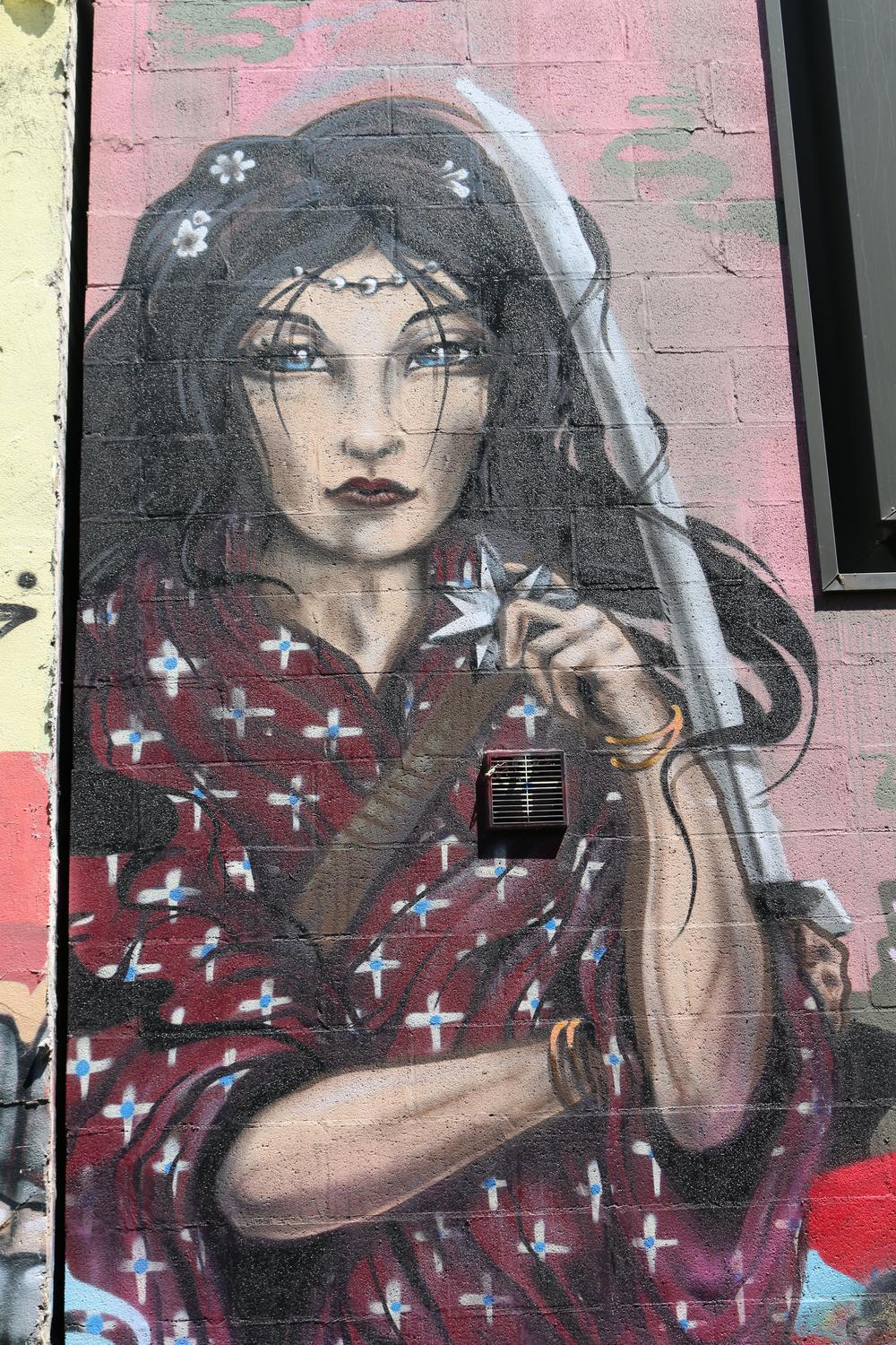 A mural of a woman in an alleyway in Fitzroy